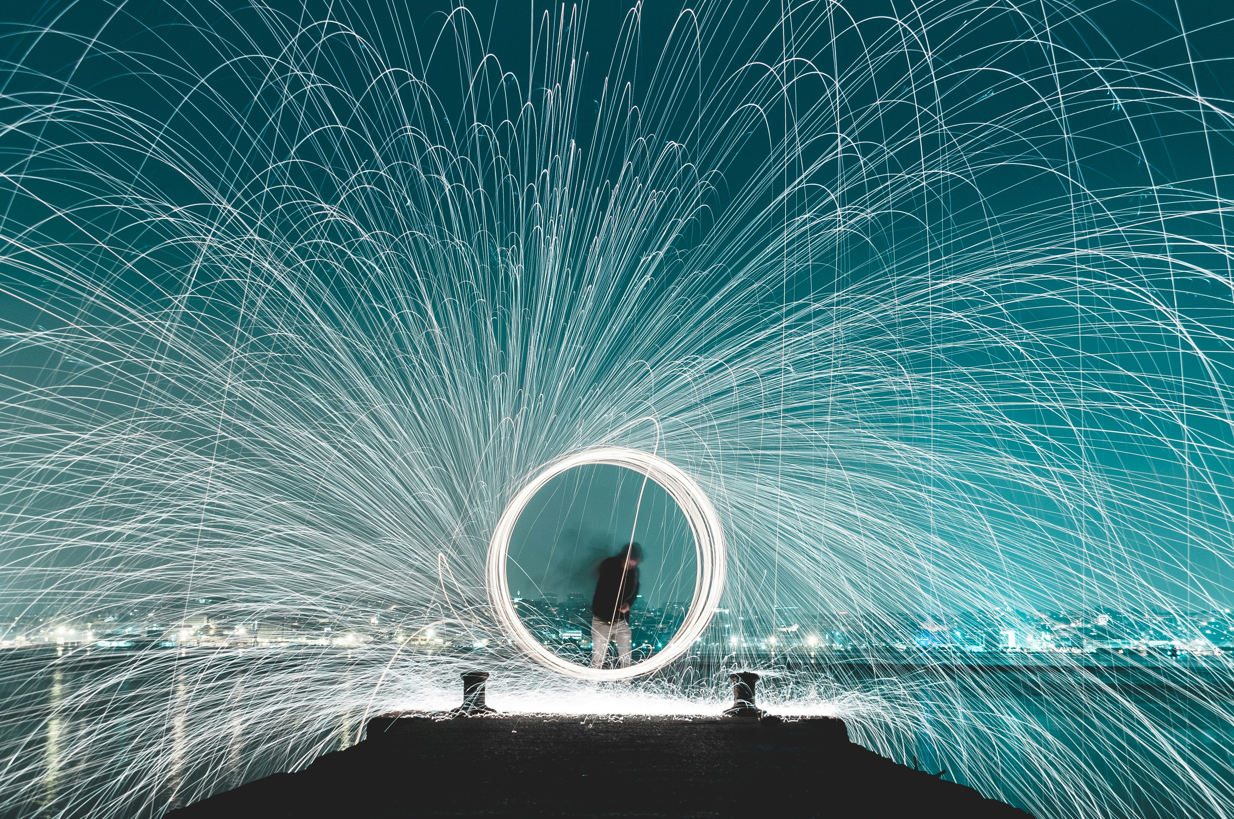 man standing on dock steel wool photography